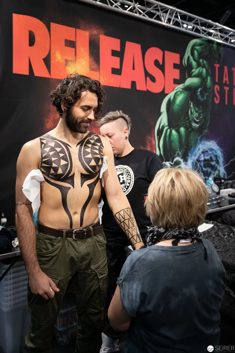 Costumed Performer at Release Event Showcases Intricate Body Art and Tribal-Inspired Design