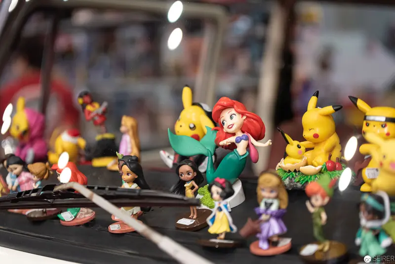 Miniature Disney and Pokémon Figurines Arranged on Detailed Display Shelf