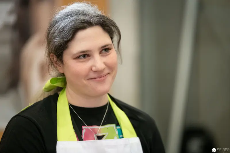 Staff Member in Green Apron at Vienna ComicCon 2019