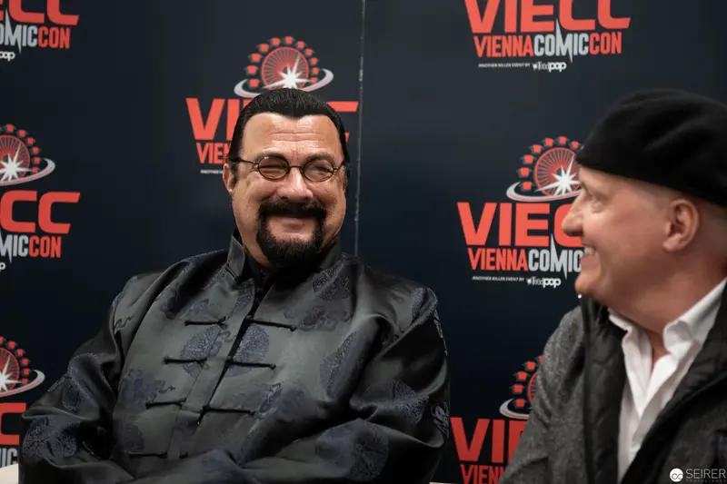 Steven Seagal at Vienna ComicCon 2019, Engaged in Conversation with Colleague