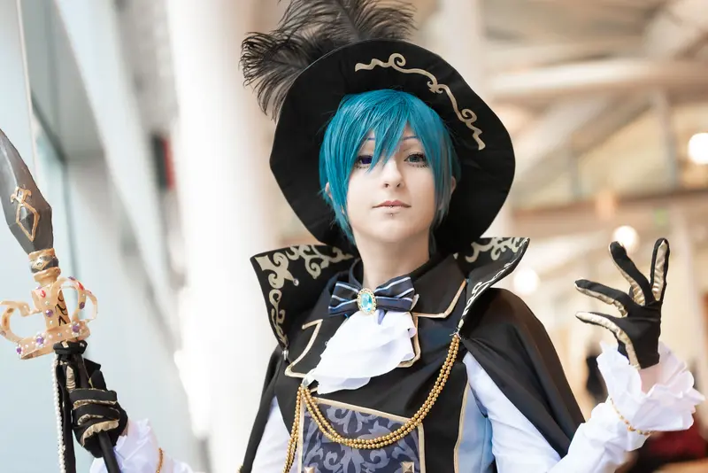 Blue-Haired Cosplayer in Ornate Black Costume at Vienna ComicCon 2019