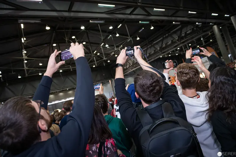 Audience Capturing Moments at Vienna ComicCon 2019 with Raised Smartphone Cameras