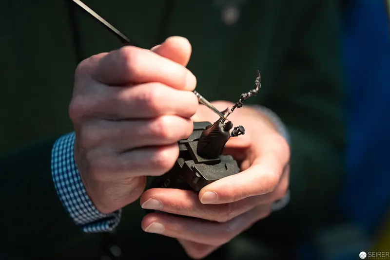 Precision Metalwork: Delicate Hand Manipulating Intricate Mechanical Component