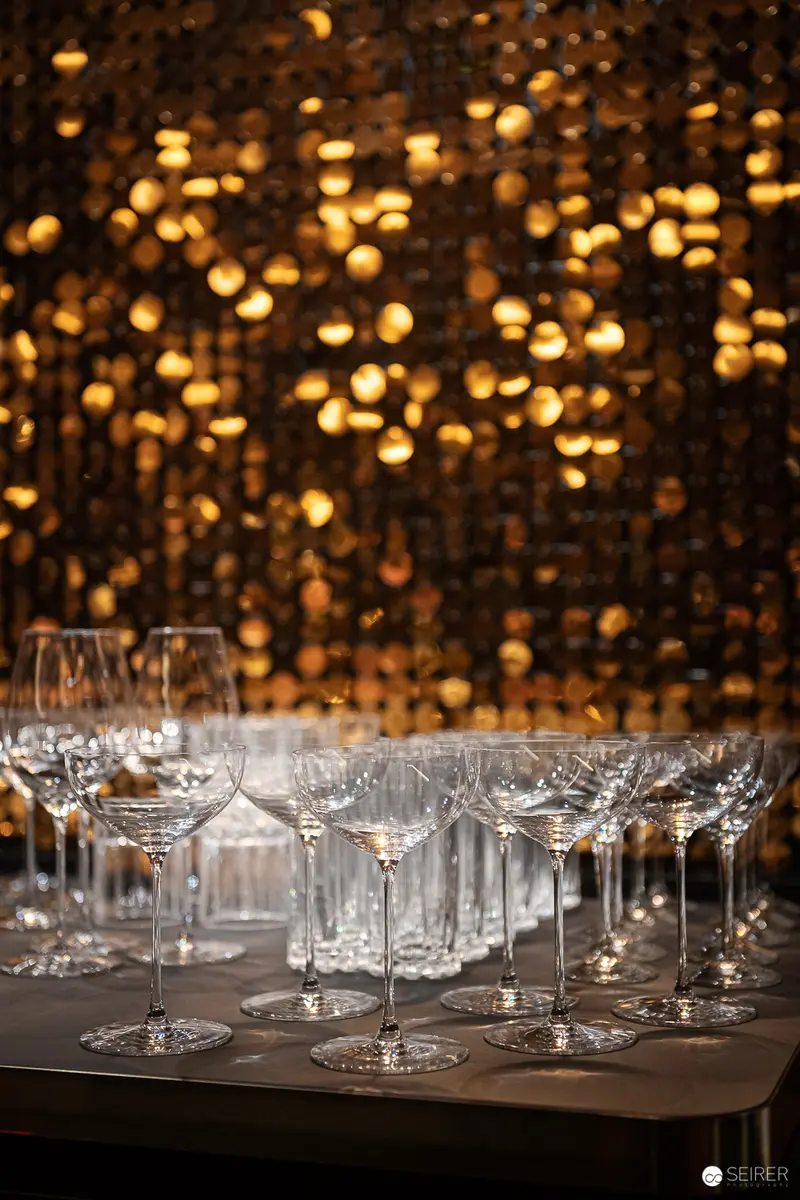 Crystal Glassware Arranged Before Golden Bokeh Illumination