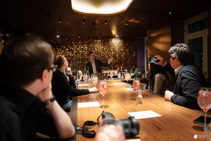 Professional Workshop Meeting with Cocktails at Illuminated Wooden Conference Table