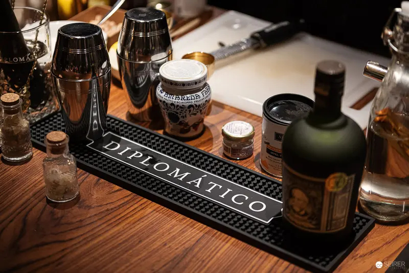 Diplomatico Bar Mat with Professional Cocktail Mixing Equipment and Spirits