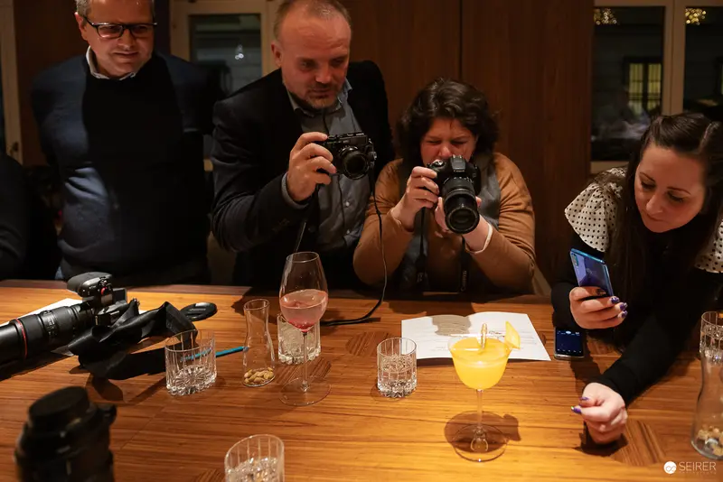 Photography Workshop Participants Examining Cameras and Documenting Session