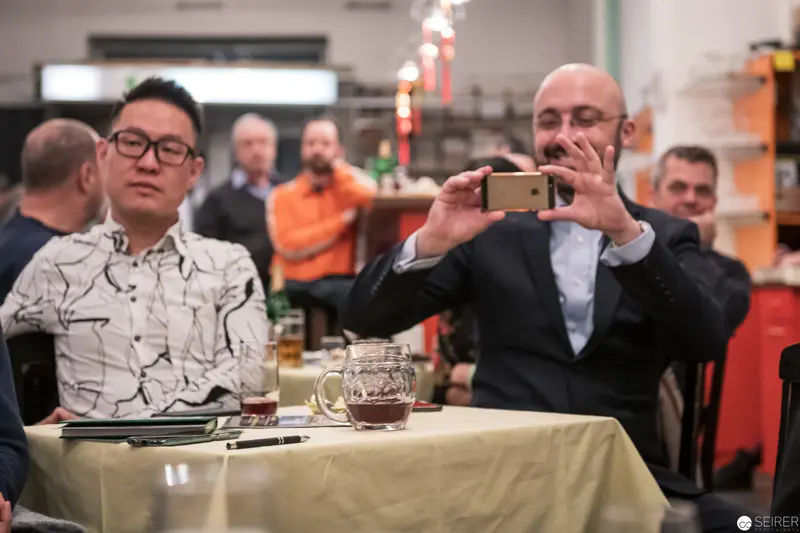 Corporate Event Documentation: Two Colleagues Photographing Workplace Gathering