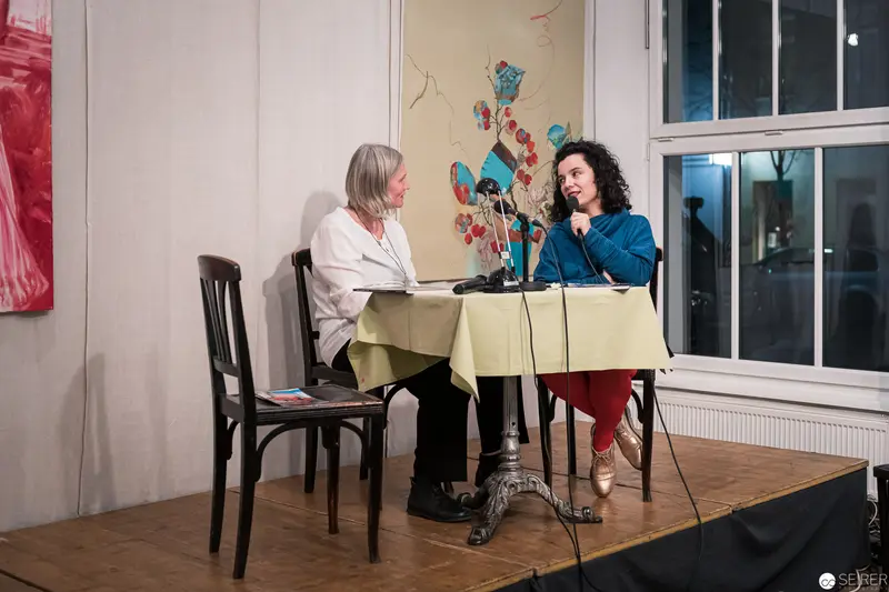 Two Women in Conversation at Staged Interview Setup