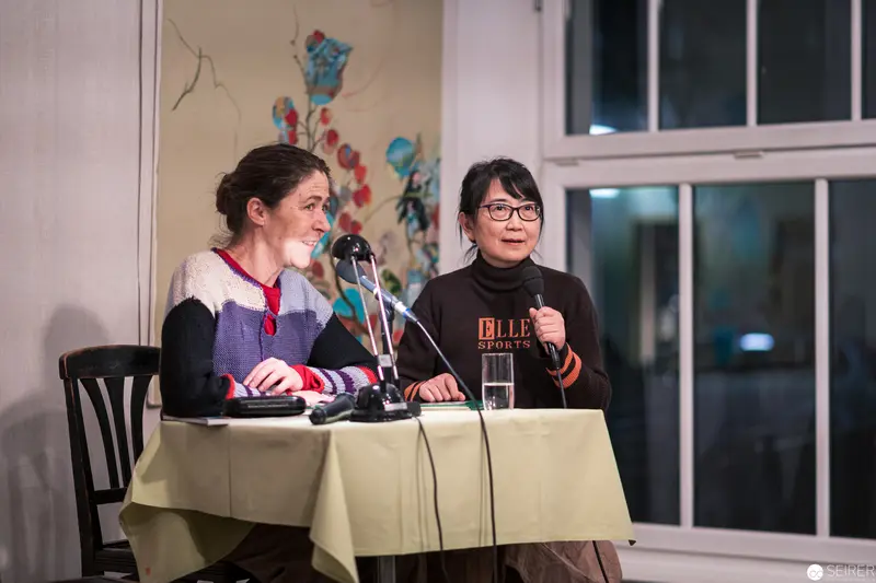 Two Women Panelists Speaking at Literary or Academic Event