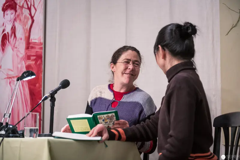 Public Reading Event with Animated Dialogue and Microphone Setup
