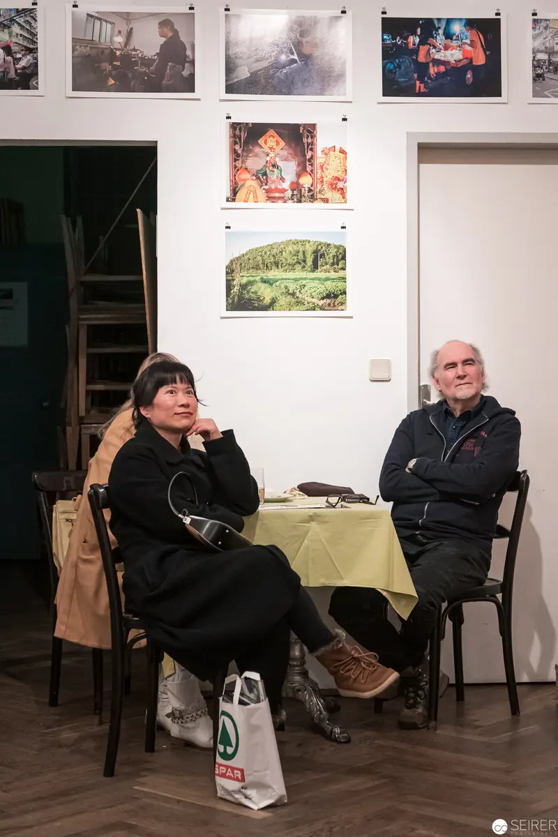 Two Figures in Gallery Space: Contemplative Moment During Art Exhibition