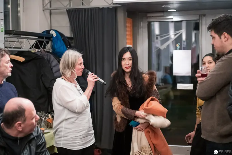 Professional Event Scene with Microphone and Informal Conversation