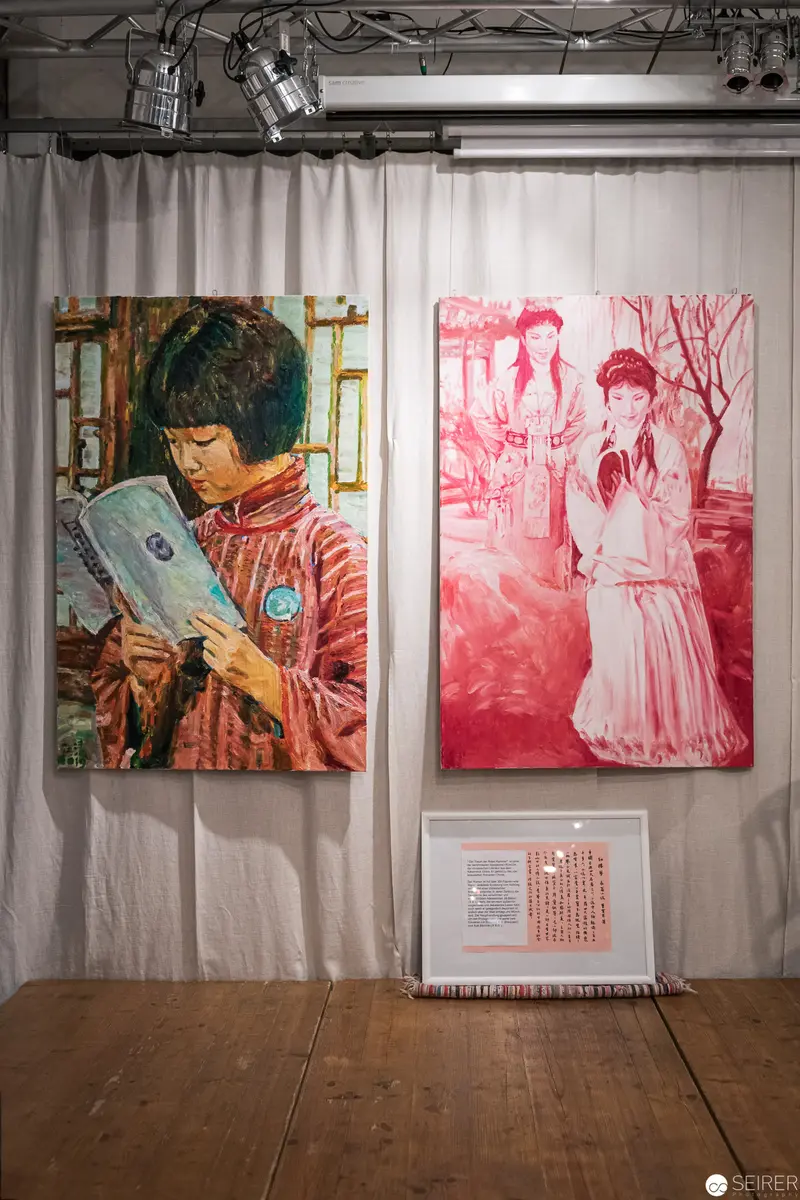 Two Monochromatic Portraits in Red and Complementary Tones on Gallery Wall