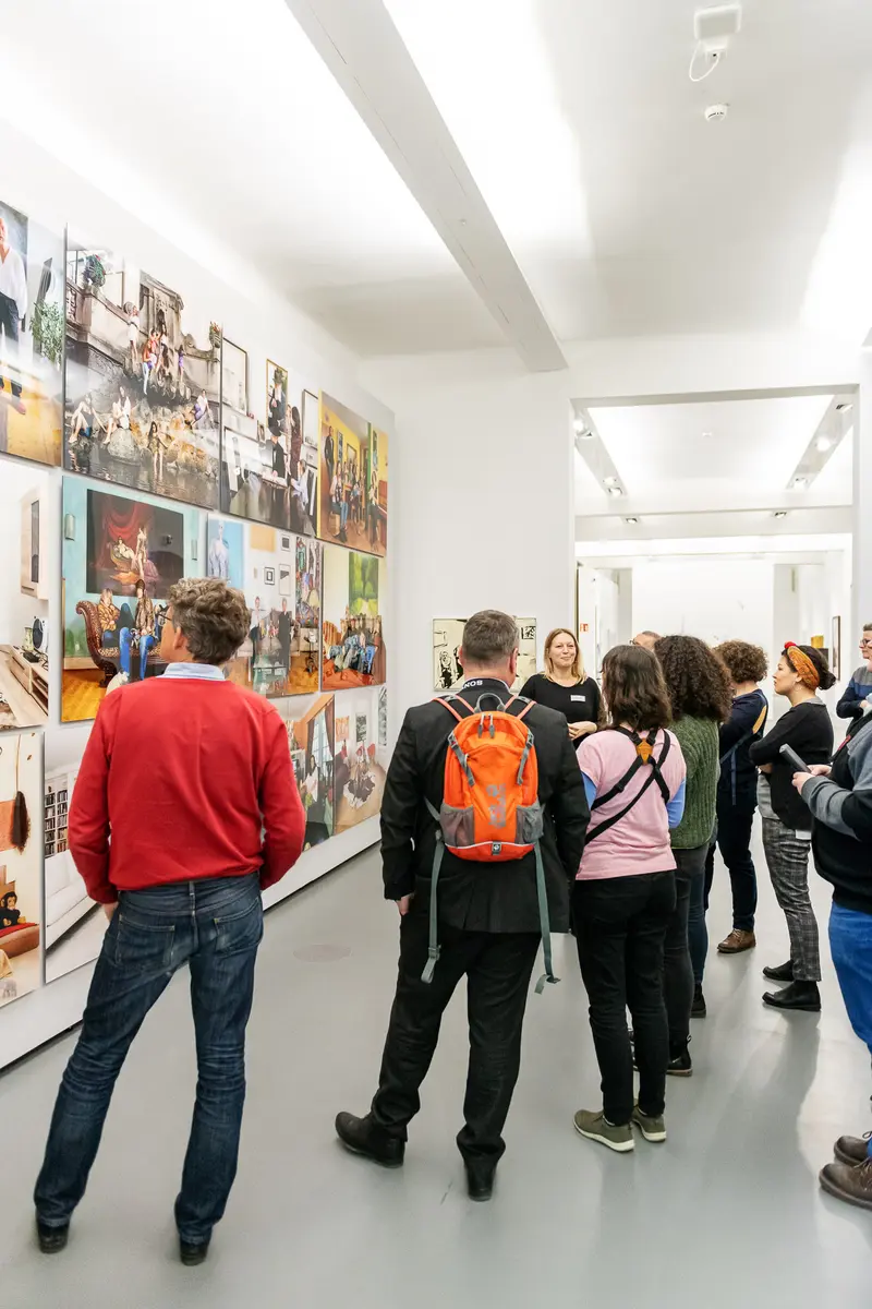 Visitors Examining Photographic Montage at "Family Matters" Exhibition at Dom Museum Vienna