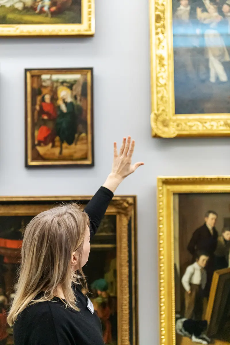 Curator Gesturing at Artwork During "Family Matters" Exhibition at Dom Museum Vienna