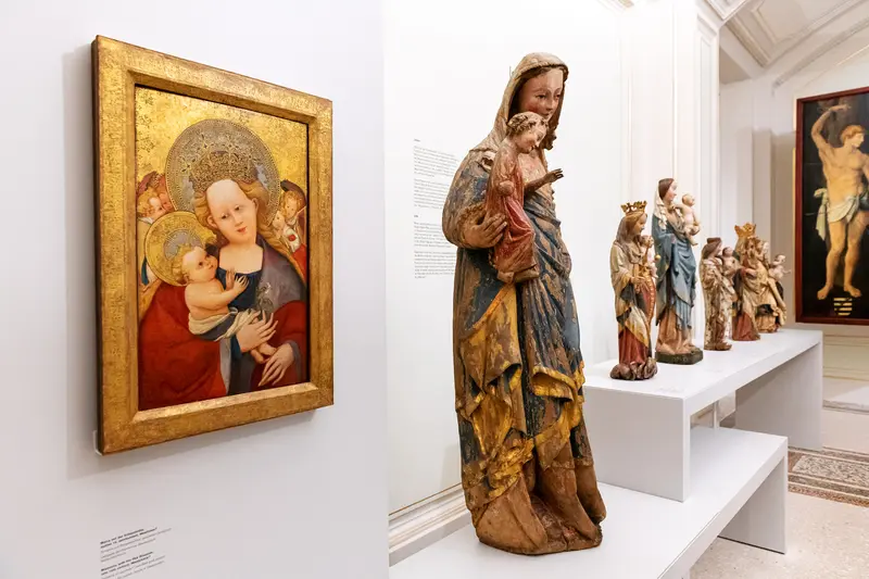 Medieval Religious Sculptures and Painting Displayed in Museum Exhibition Space