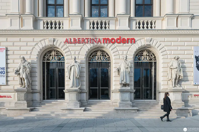 Albertina Modern Museum Facade with Architectural Statues and Arched Entryways
