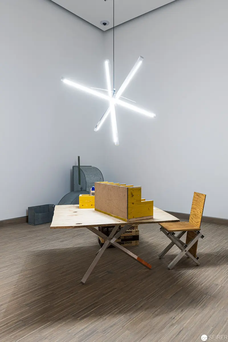 Minimalist Interior with Star-Shaped Light Installation and Wooden Furniture