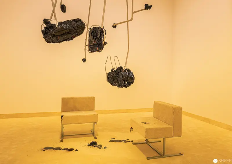 Suspended Organic Forms and Minimalist Chairs in Monochromatic Installation