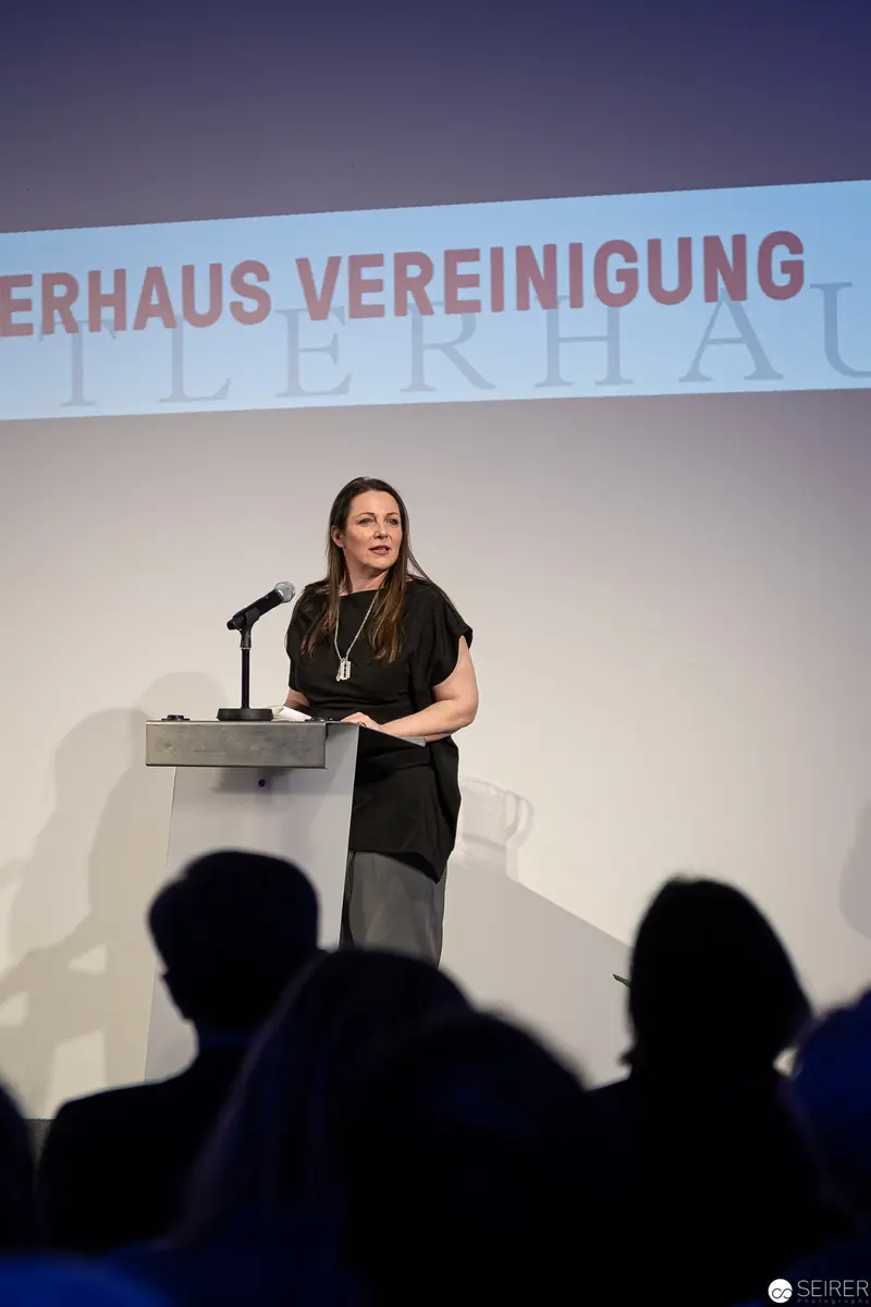 Woman Speaking at Podium During Künstlerhaus Vereinigung Wien Event