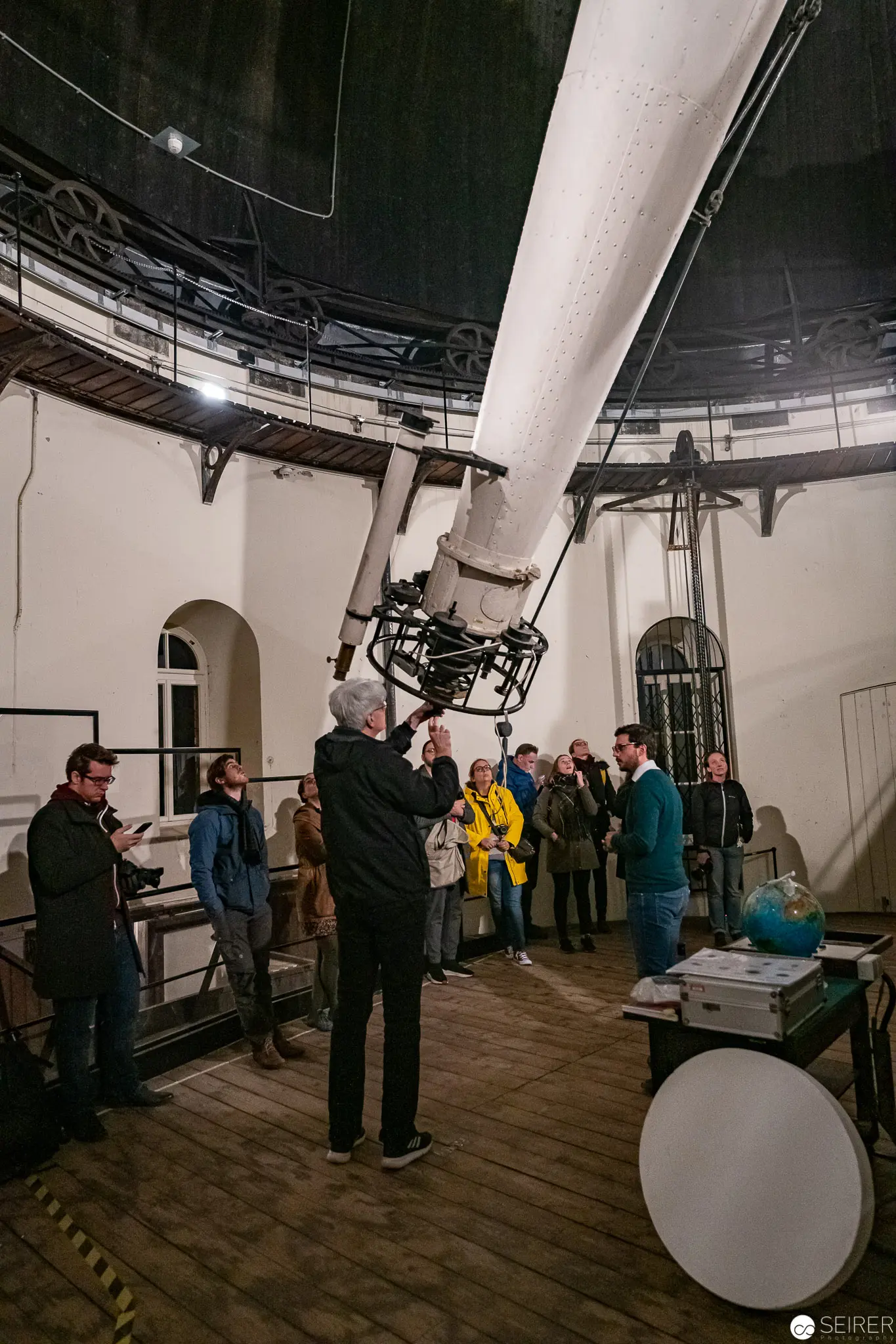 Tour Group Examining Large Telescope at Unisternwarte Observatory in Vienna