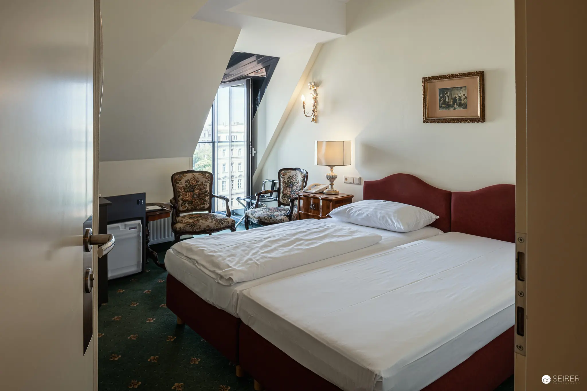 Elegant Attic Hotel Room with Antique Furnishings at Hotel Regina