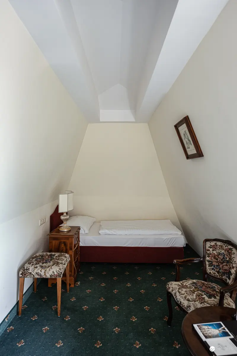 Intimate Attic Hotel Room with Vintage Decor at Hotel Regina