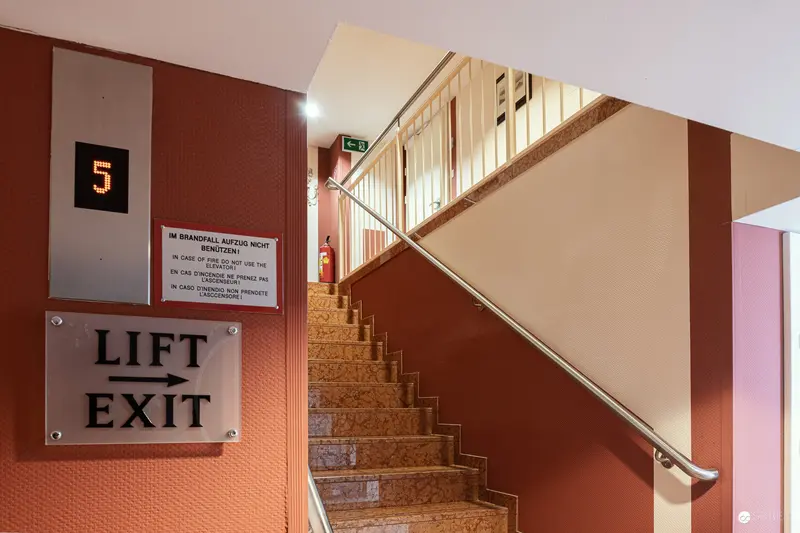 Interior Architectural Detail of Hotel Regina Stairwell with Lift Exit Signage