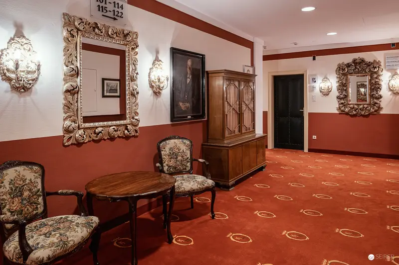 Ornate Hotel Regina Interior with Baroque-Style Mirrors and Tapestry Chairs