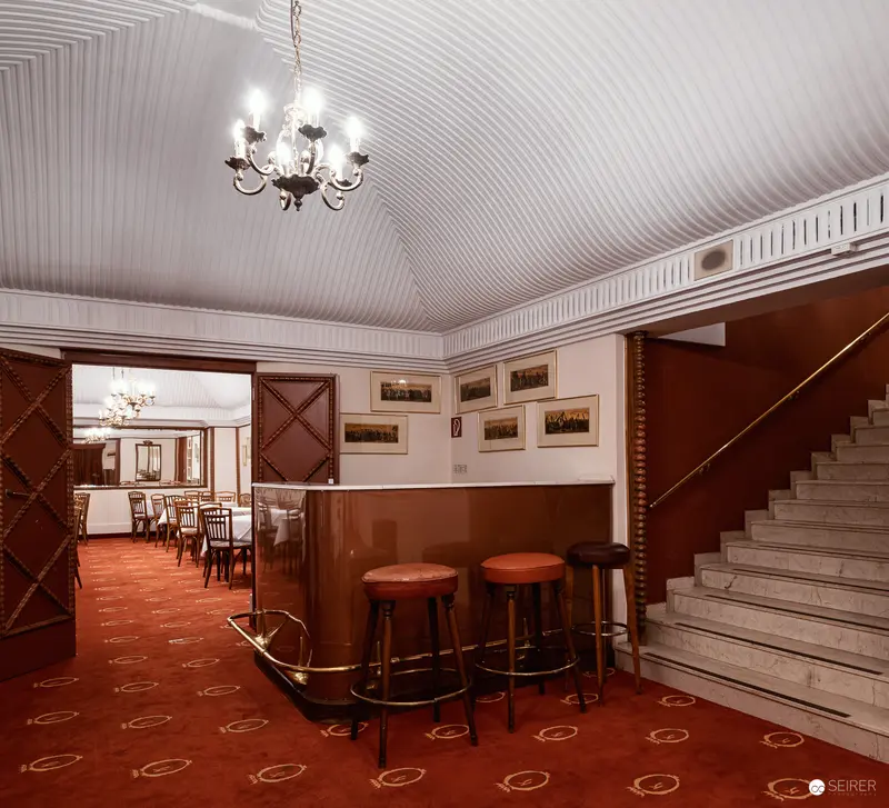 Regina Hotel Interior: Vintage Lobby with Red Carpet and Elegant Chandelier