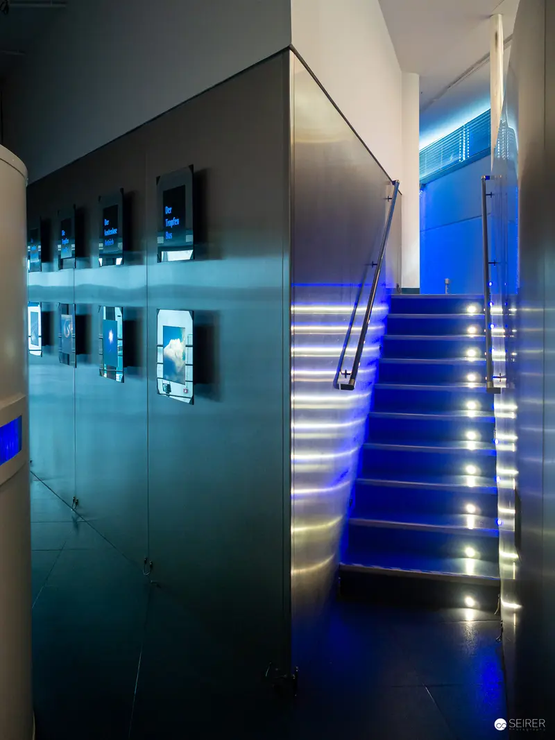 Blue-Illuminated Architectural Staircase with Modern Interior Design Elements