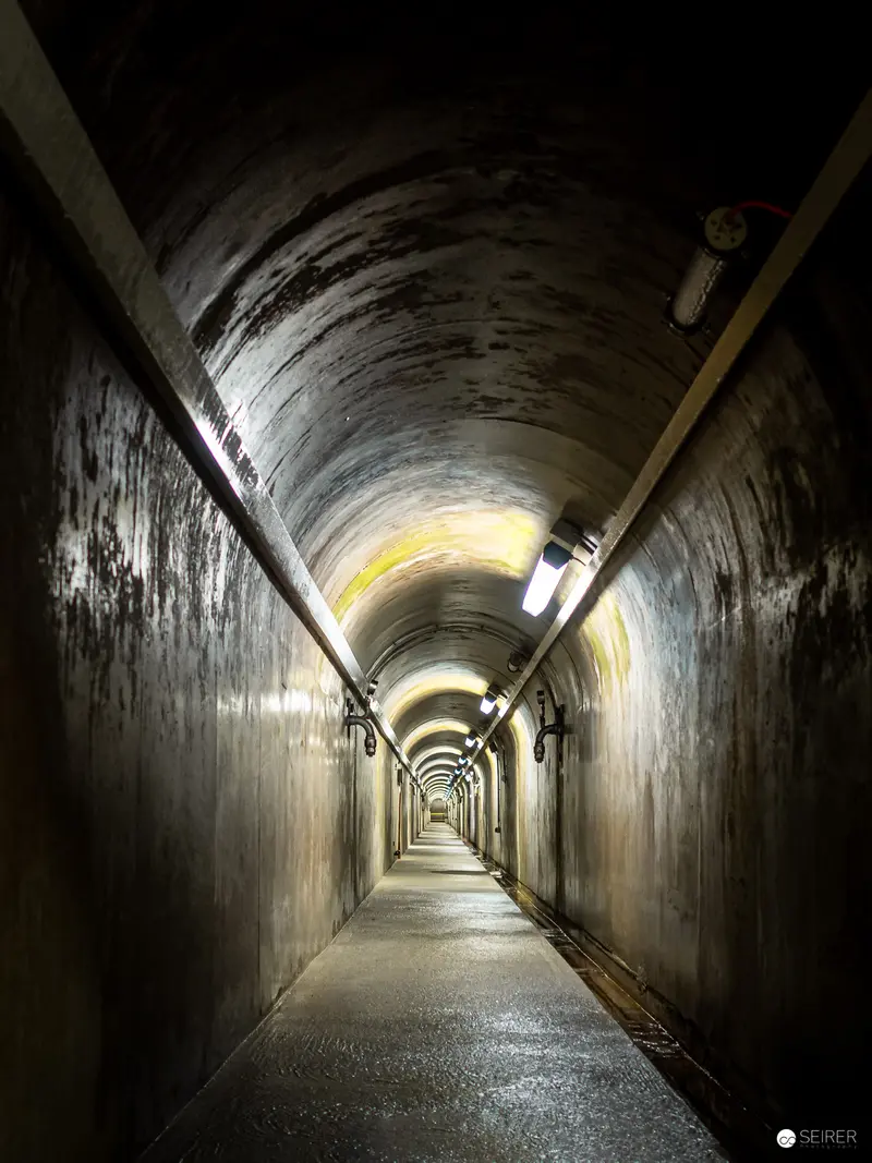Concrete Tunnel Interior with Arched Ceiling and Dramatic Lighting at Kraftwerk Freudenau