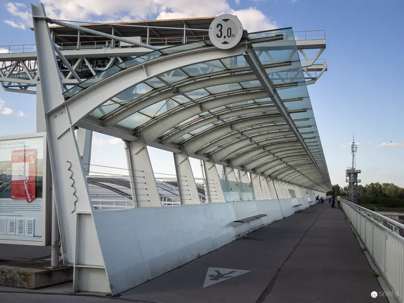 Modern Urban Pedestrian Bridge with Arched Glass Canopy and 3.0 Marker