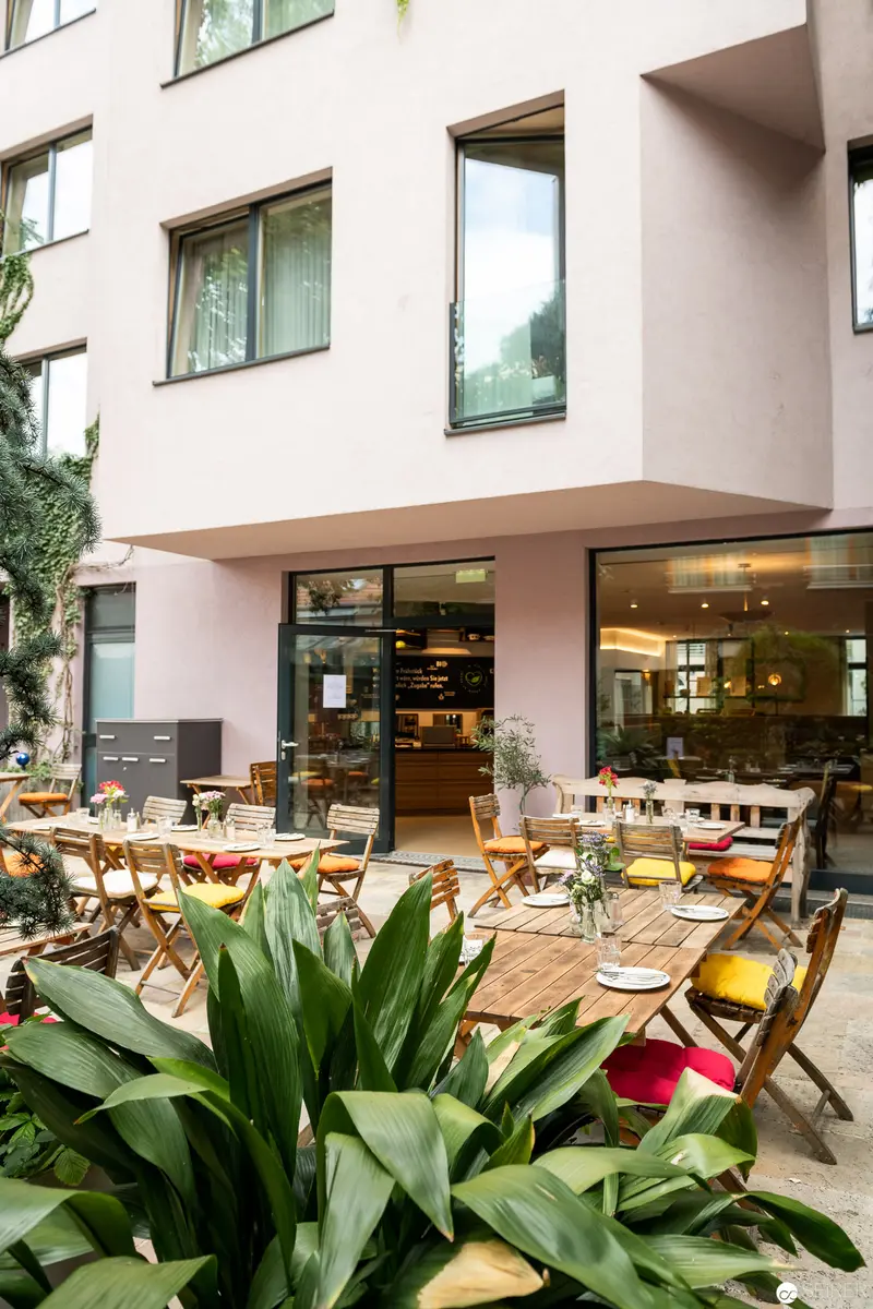 Vienna's Stadthalle Boutique Hotel: Urban Dining Terrace with Verdant Greenery