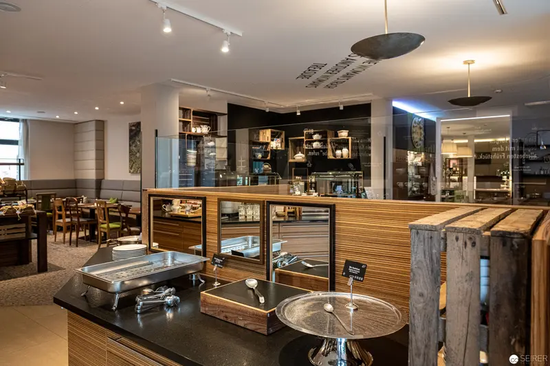 Modern Café Interior at Stadthalle Vienna with Wooden Design and Open Kitchen