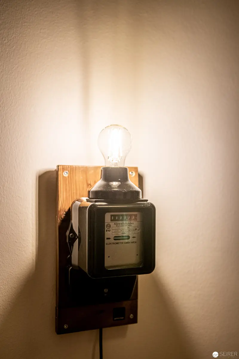 Vintage Electric Meter Transformed into Atmospheric Wall Lamp at Stadthalle Hotel, Vienna