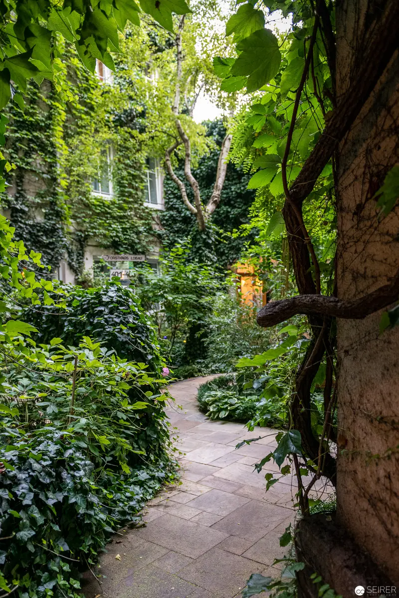 Verdant Pathway at Stadthalle: An Ivy-Covered Urban Garden Retreat in Vienna
