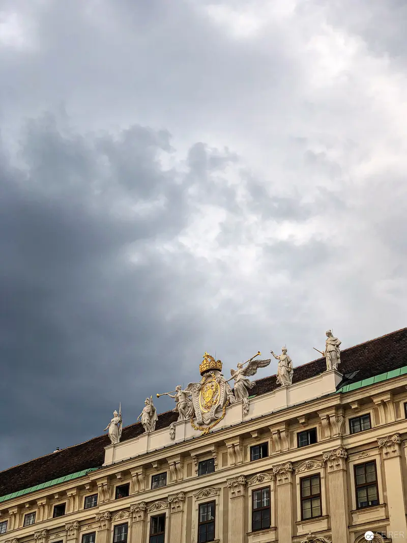 Baroque Architectural Detail with Sculptural Ornamentation Against Stormy Viennese Sky
