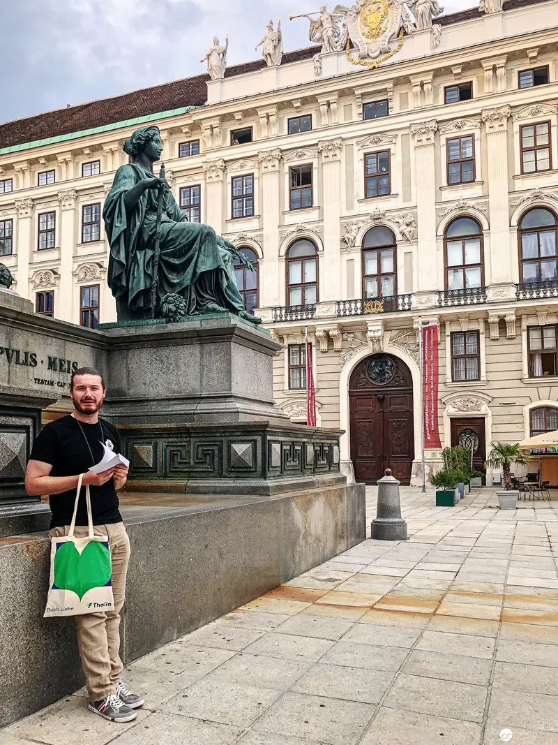 Tourist Posing Near Statue and Baroque Palace in Historic Vienna Urban Landscape