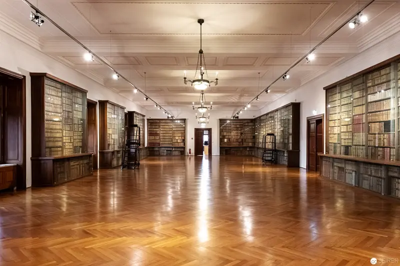 Elegant Library Hall with Herringbone Parquet and Illuminated Book Shelves