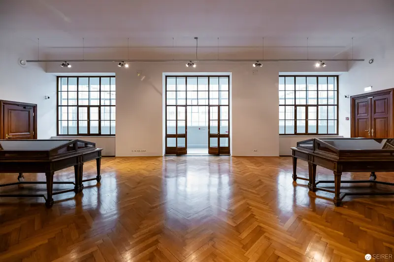 Empty Gallery Space with Antique Display Cases and Herringbone Parquet Flooring