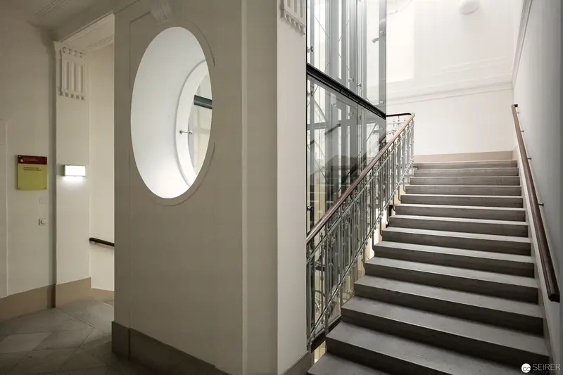 Modern Architectural Interior with Curved Window and Staircase at National Library Archive