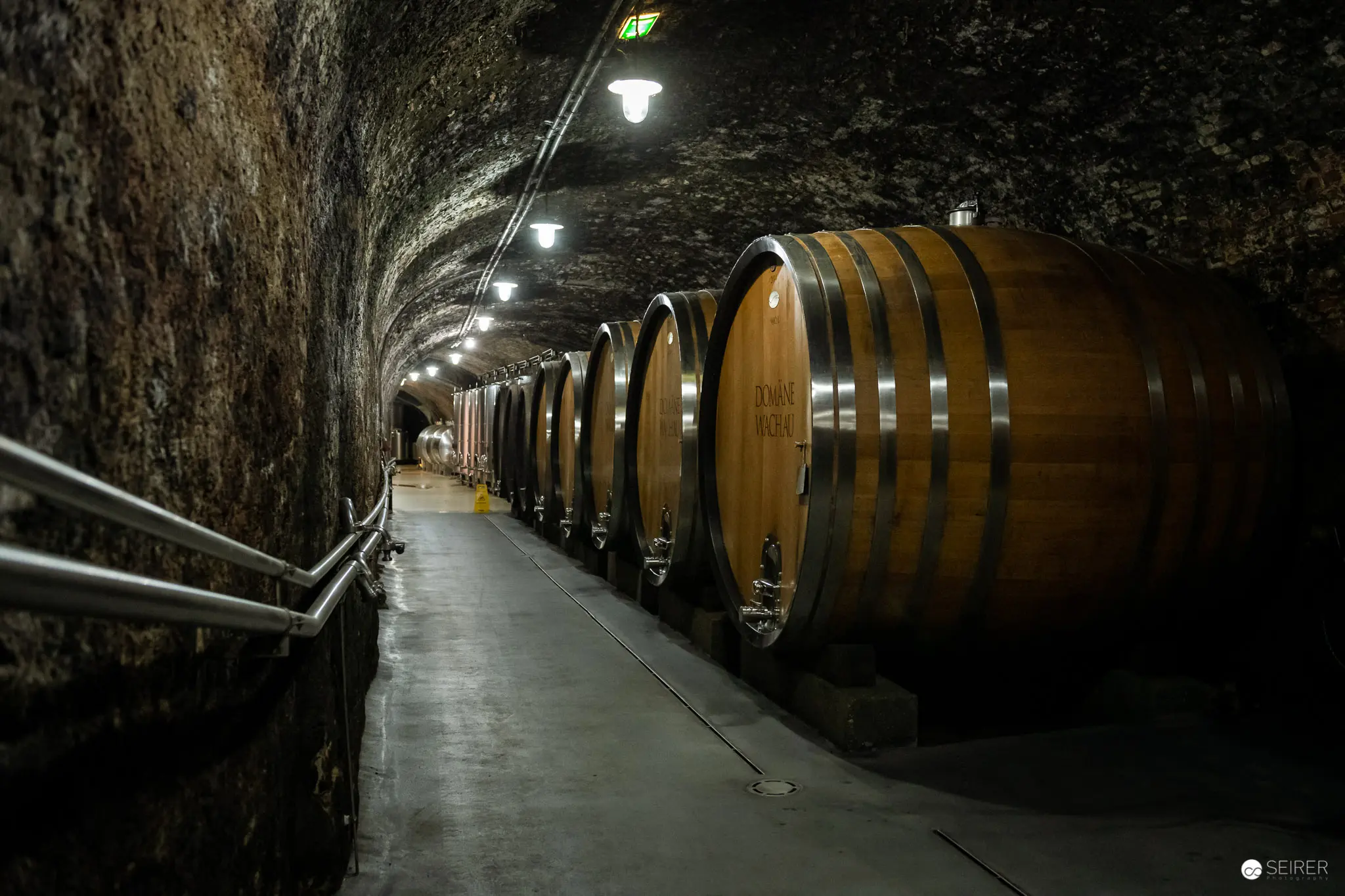 Wooden Wine Barrels in Underground Cellar Tunnel at Domäne Wachau Winery
