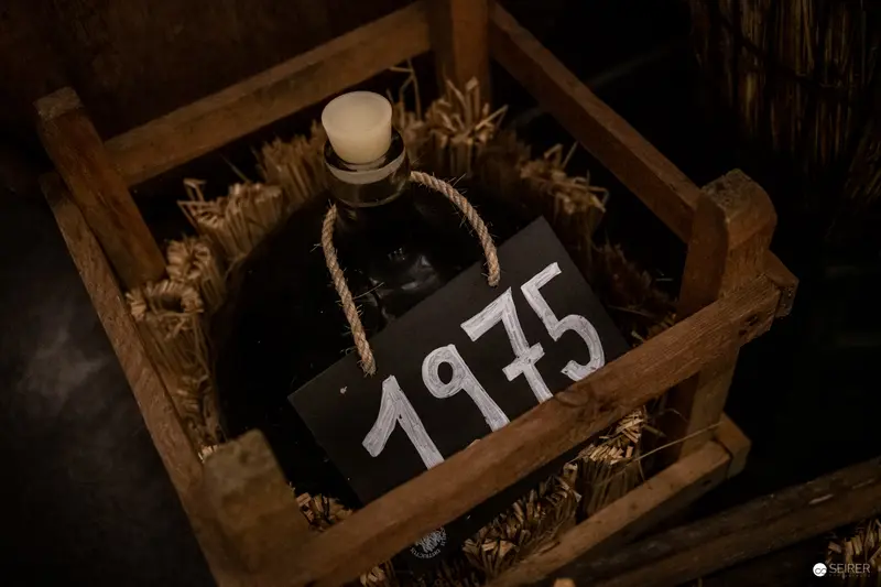 Vintage 1975 Wine Bottle in Rustic Wooden Crate at Domäne Wachau Winery
