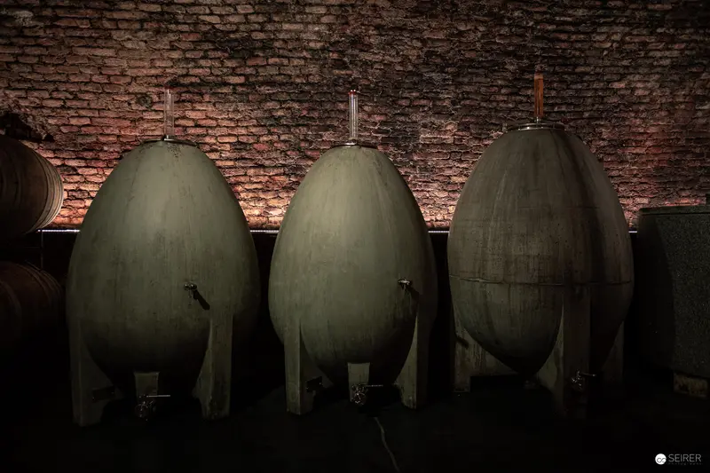 Aged Wine Vessels in Dimly Lit Winery Cellar at Domäne Wachau