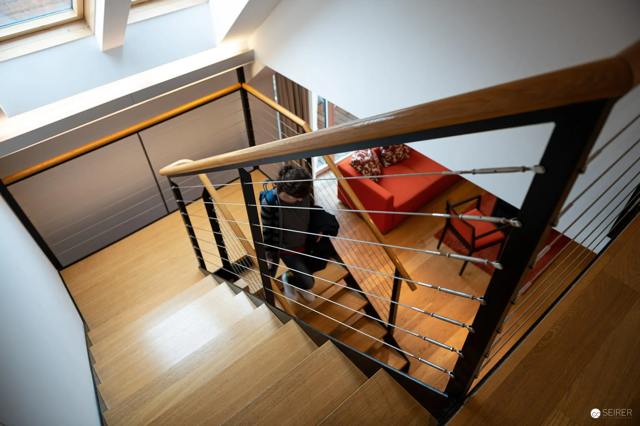 Modern Staircase Interior with Wooden Floors and Metal Railing Design