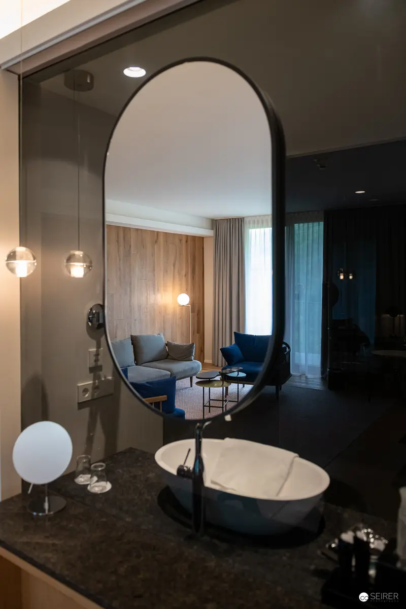 Contemporary Hotel Room Interior Reflected in Arched Mirror with Modern Furnishings