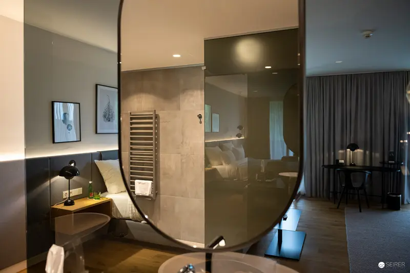 Modern Hotel Room Interior with Curved Glass Partition and Minimalist Design