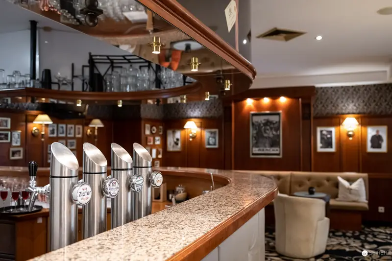 Modern Bar Interior with Polished Beer Taps and Wood-Paneled Walls